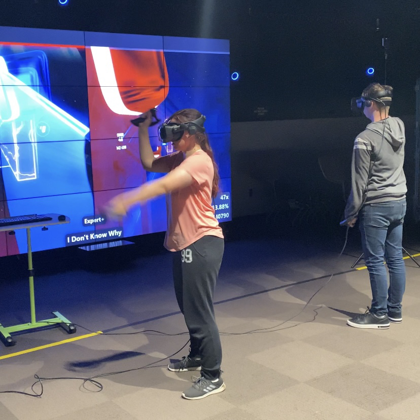 A photo of the final tournament setup with people playing a map