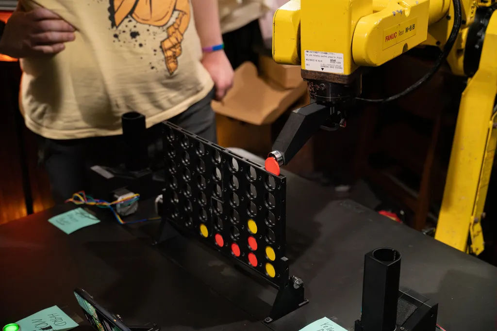A photo of the robot arm playing connect four