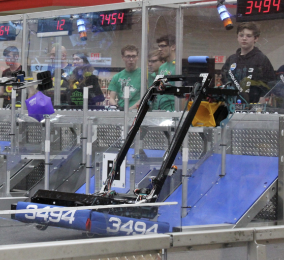 A photo of our 2023 FRC robot placing a game piece